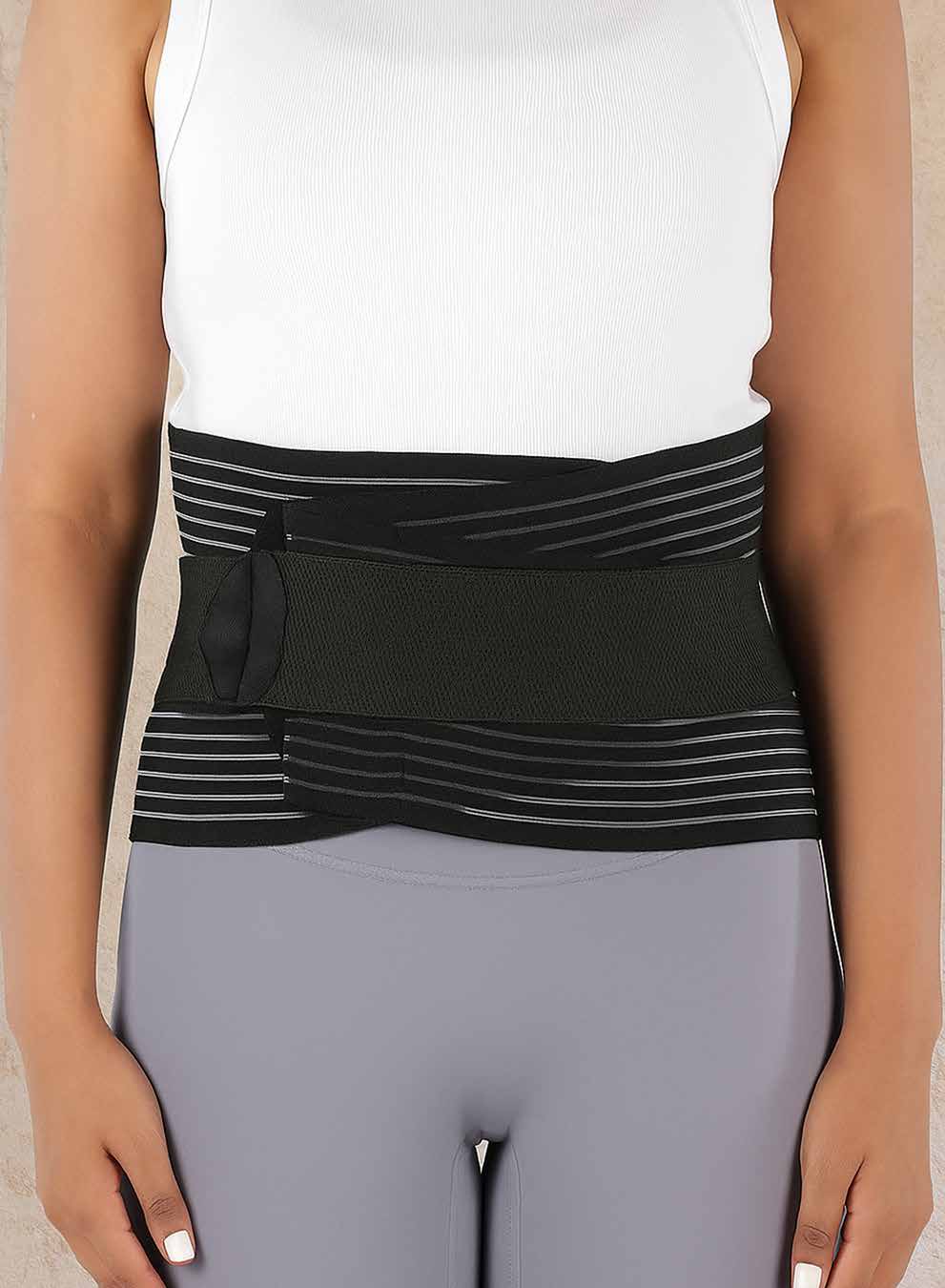 Model wearing the broad black-and-grey striped lumbar sacral belt around the abdomen.